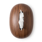 Dark brown, oval-shaped tissue dispenser with a wood grain texture, featuring a white tissue emerging from its central opening.
