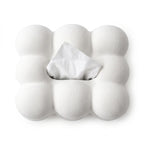 Textured white cloud-shaped tissue dispenser with a single white tissue peeking out from the center opening, on a white background.
