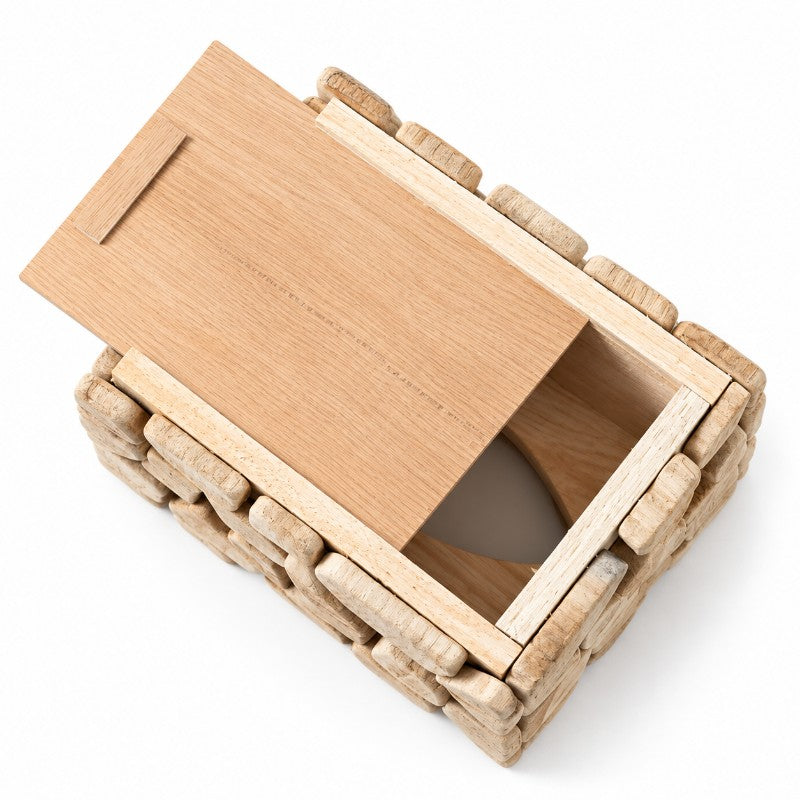 Overhead view of a light wood mosaic tissue box with a smooth light brown lid partially slid open, revealing the empty interior.