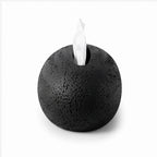 Spherical black textured dispenser with a white tissue emerging from a narrow slot on its top, isolated on white.